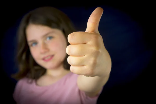 Portrait of beautiful little girl showing ok sign