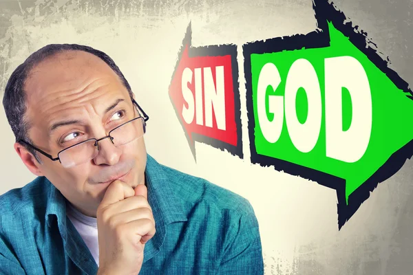 Portrait of adult man faced with choice between SIN and GOD