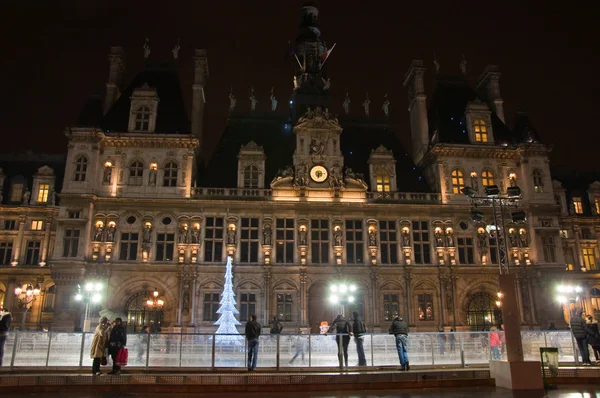 PARIS-JANUARY 9: Christmas ice skating and illuminated the Hotel de ville at night on January 9,2012 in Paris. Hotel de ville is the building housing the City of Paris\'s administration.