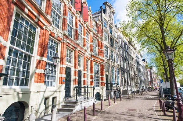 Amsterdam street with 17th century residence buildings in the city center, Netherlands.