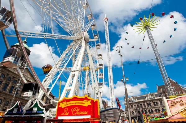 AMSTERDAM,NETHERLANDS-APRIL 27: Attractions on Dam Square during King\'s Day on April 27,2015 in Amsterdam.