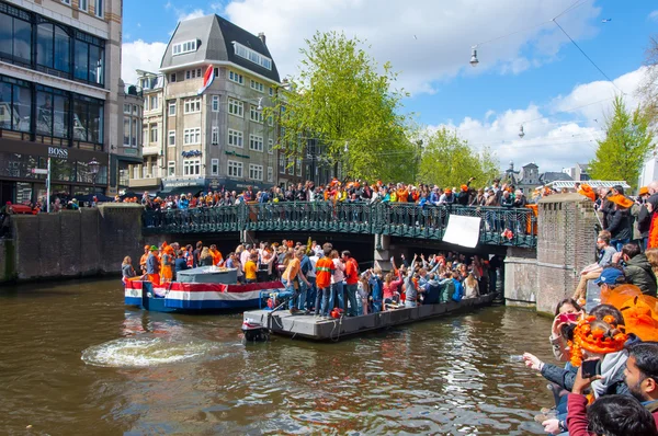 AMSTERDAM-APRIL 27: Singel Amsterdam canal  with crowd of people on the bridge during King\'s Day on April 27,2015.