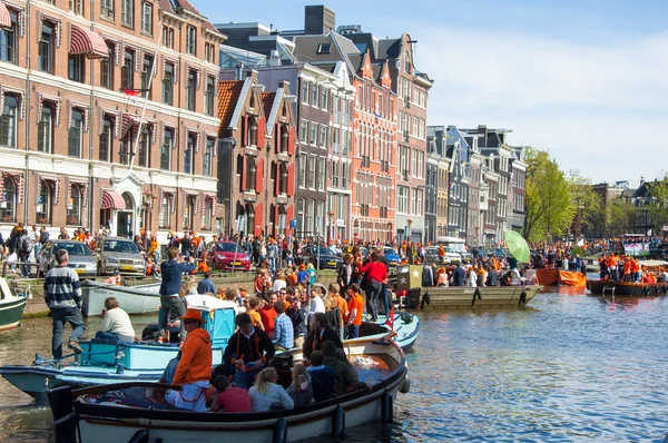 AMSTERDAM-APRIL 27: Crowd of people on the boats participate in celebrating King\'s Day on April 27,2015 the Netherlands.