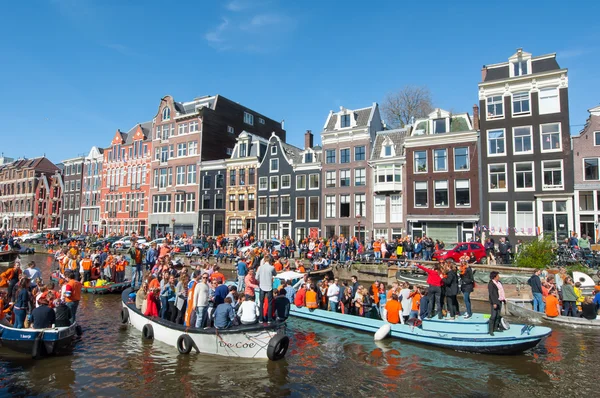 AMSTERDAM-APRIL 27: Crowd of people on boats take part in celebrating King\'s Day on April 27,2015 the Netherlands.