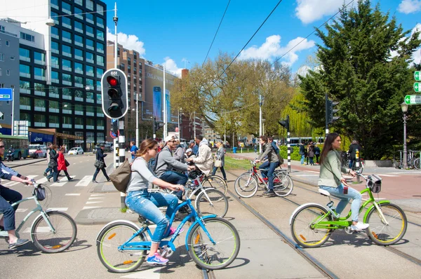 AMSTERDAM-APRIL 30: Local people on bicycles cross the road on April 30,2015, the Netherlands.