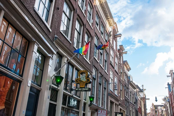 Amsterdam-April 30: Rainbow flags on the medival building in red light district on April 30,2015.