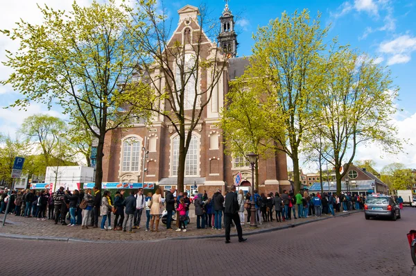Tourists stand in a queue to get to Anne Frank House Museum, Amsterdam.