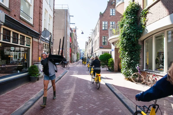 Jordaan neighbourhood, tourists ride bicycles in Amsterdam.