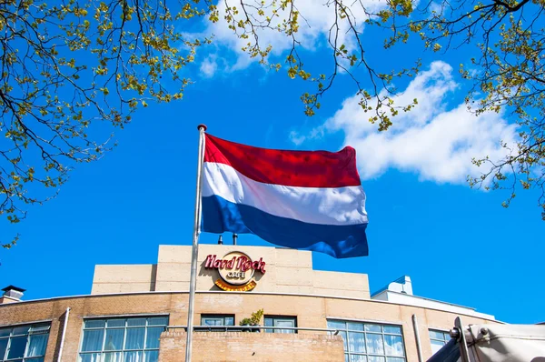 Holland flag and Hard Rock Cafe signage on the backgroud in Amsterdam.