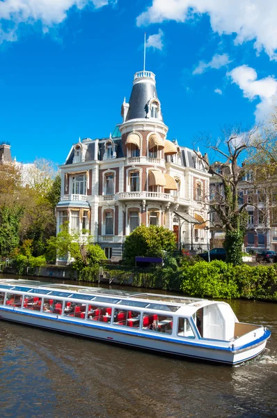 Boat Cruising on Amsterdam Singelgrachtkering Canal, the Netherlands.