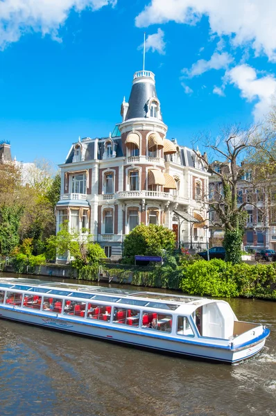 Boat Cruising on Amsterdam Singelgrachtkering Canal.