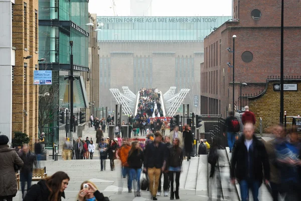 People walking over Millennium bridge