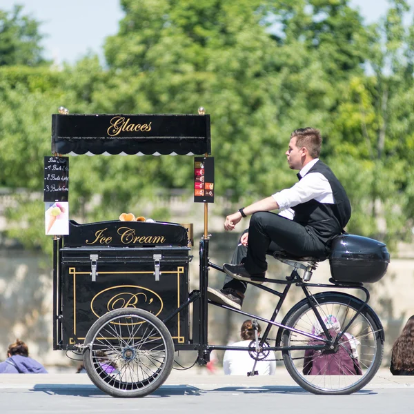 Ice cream seller with bicycle on the street.