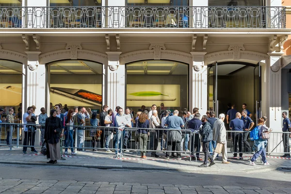 People in queue outside the Apple Store