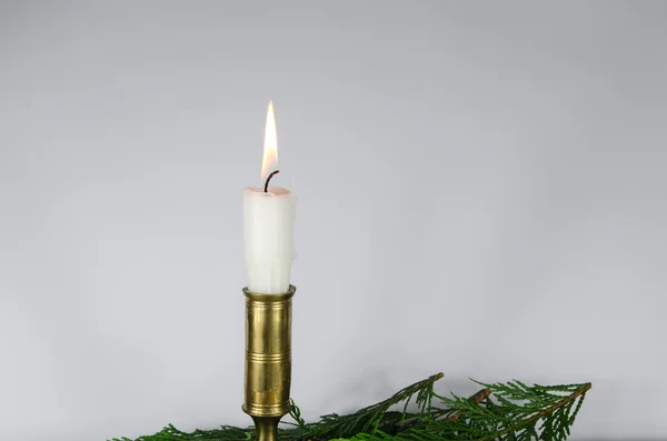 One white candle at a white background