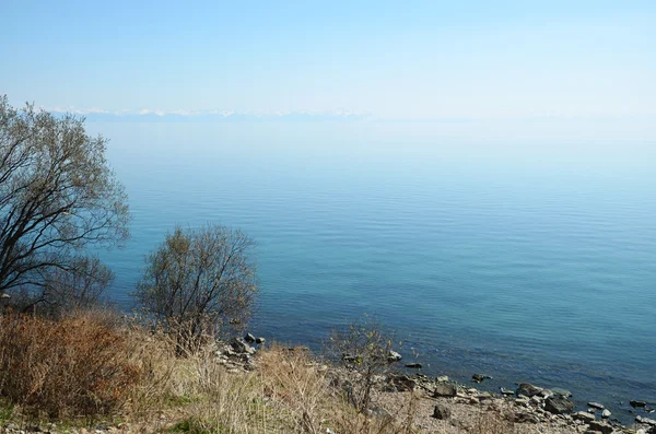 The smooth calm surface of Lake Baikal in spring