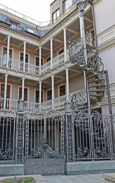 House with traditional balconies and wrought-iron spiral staircase. Tbilisi