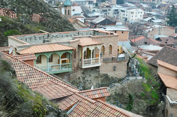Unfinished house, where there is no roof, but there are carved balconies. Tbilisi, Old Town