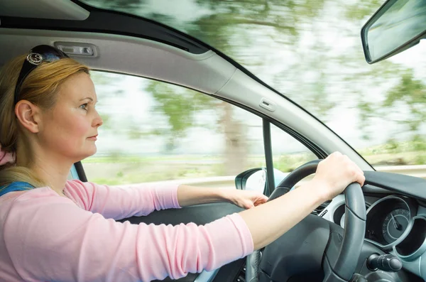 Profile portrait of serious calm woman carefullly safe driving c