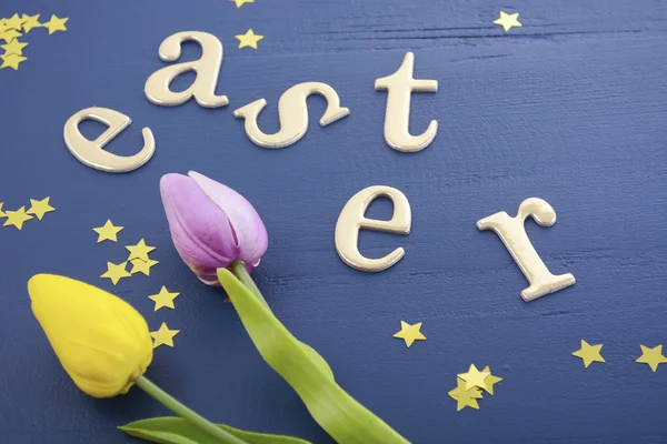 Gold Easter Letters on Wood Background.