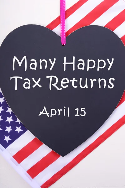 USA Tax Day blackboard and flag.