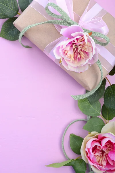 Feminine background with gift and silk roses