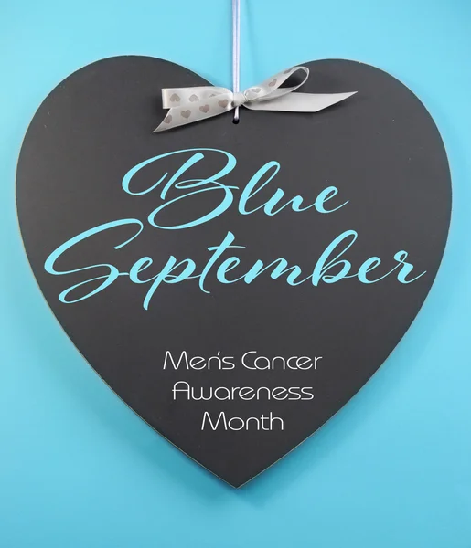 Blue September for mens health awareness month message greeting on heart shape blackboard