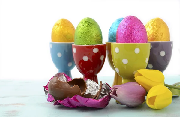 Happy Easter bright colour eggs in egg cups.