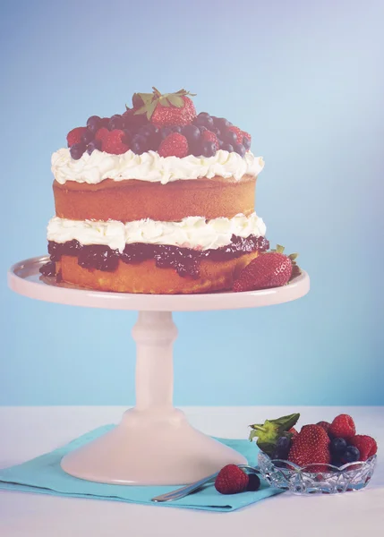 Fresh whipped cream and berries layer sponge cake.