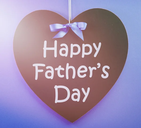 Happy Fathers Day message written on a black blackboard with blu
