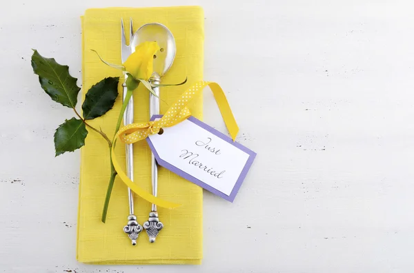 Yellow and white theme wedding table place setting.