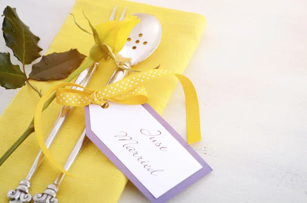 Yellow and white theme wedding table place setting.