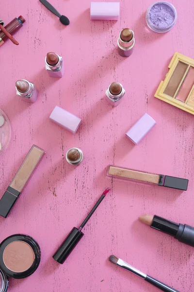 Makeup Items on Vintage Pink Wood Table