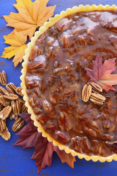 Traditional Thanksgiving Pecan Pie on Dark Blue Wood.