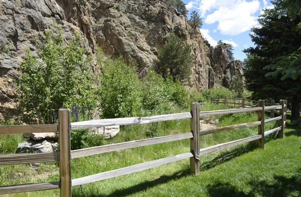 Split Rail fence bordering a rocky cliff area