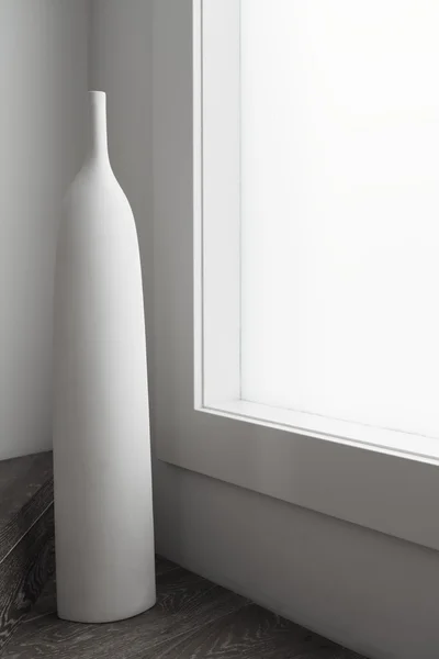 Large white vase ornament sculpture next to large window