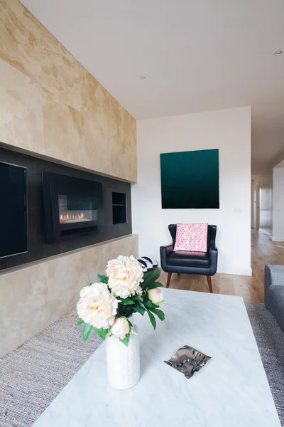 Comfy leather armchair in with pink cushion in living room