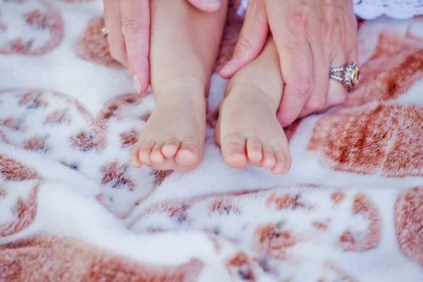 Baby hands and feet fingers and mom hands