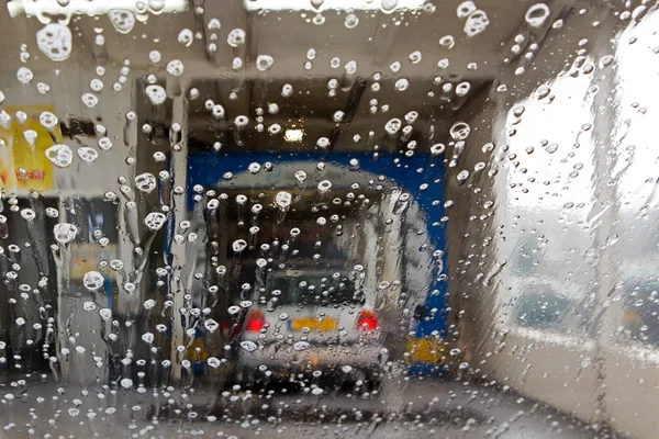 Hoogeveen, Netherlands - September 24, 2014: Water drops on car window in Car Wash, Netherlands