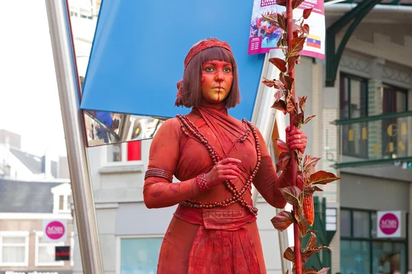 Arnhem, Netherlands - September 28, 2014: artist lady in red during world championships living statues in Arnhem