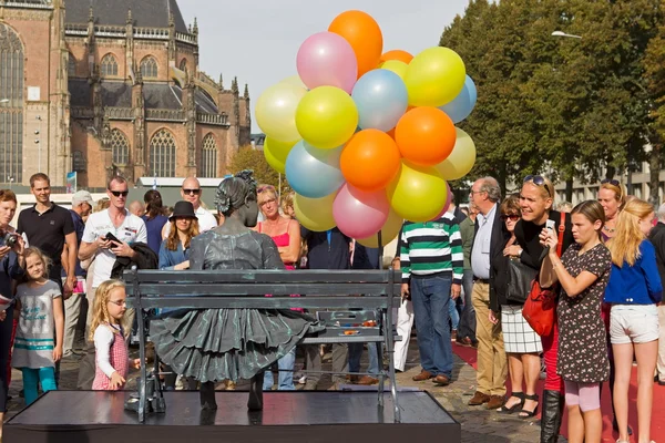 Arnhem, Netherlands - September 28, 2014: Girl with balloons on chair during the world championships living statues in Arnhem