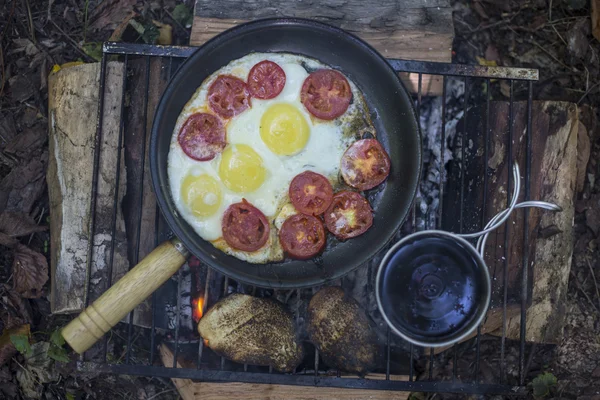 Camping cooking breakfast.