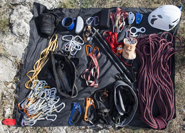 Climbing gear.Climbing gear laid out on a stone in front of the ascent.