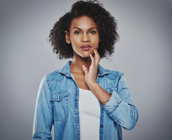 Serious woman with fingers on chin