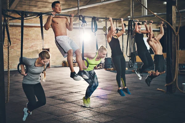 Fit young people doing pullups