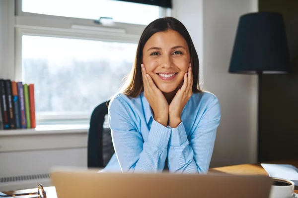 Happy young businesswoman working from home