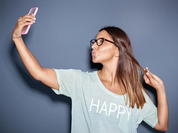 Young woman posing for a funny selfie