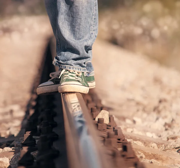 Legs in sneackers on the railway