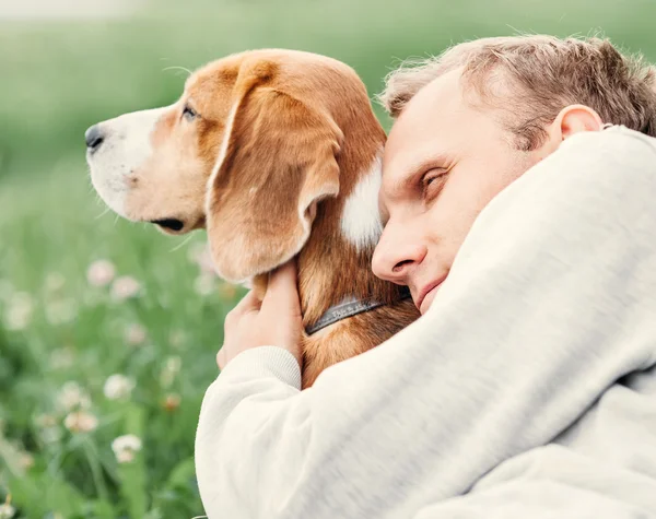 Man hugs his dog