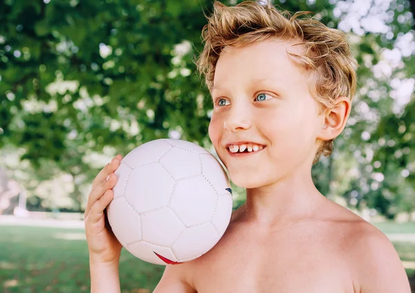 Boy with ball  in summer park